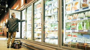 Photo of man getting items out of refrigerated dairy case