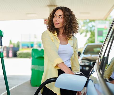 Woman placing car charger to her vehicle