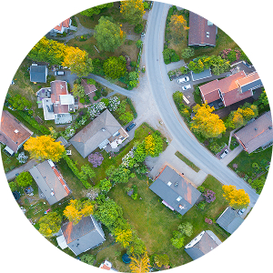 Overhead view of a neighborhood with a main road running through residential houses.